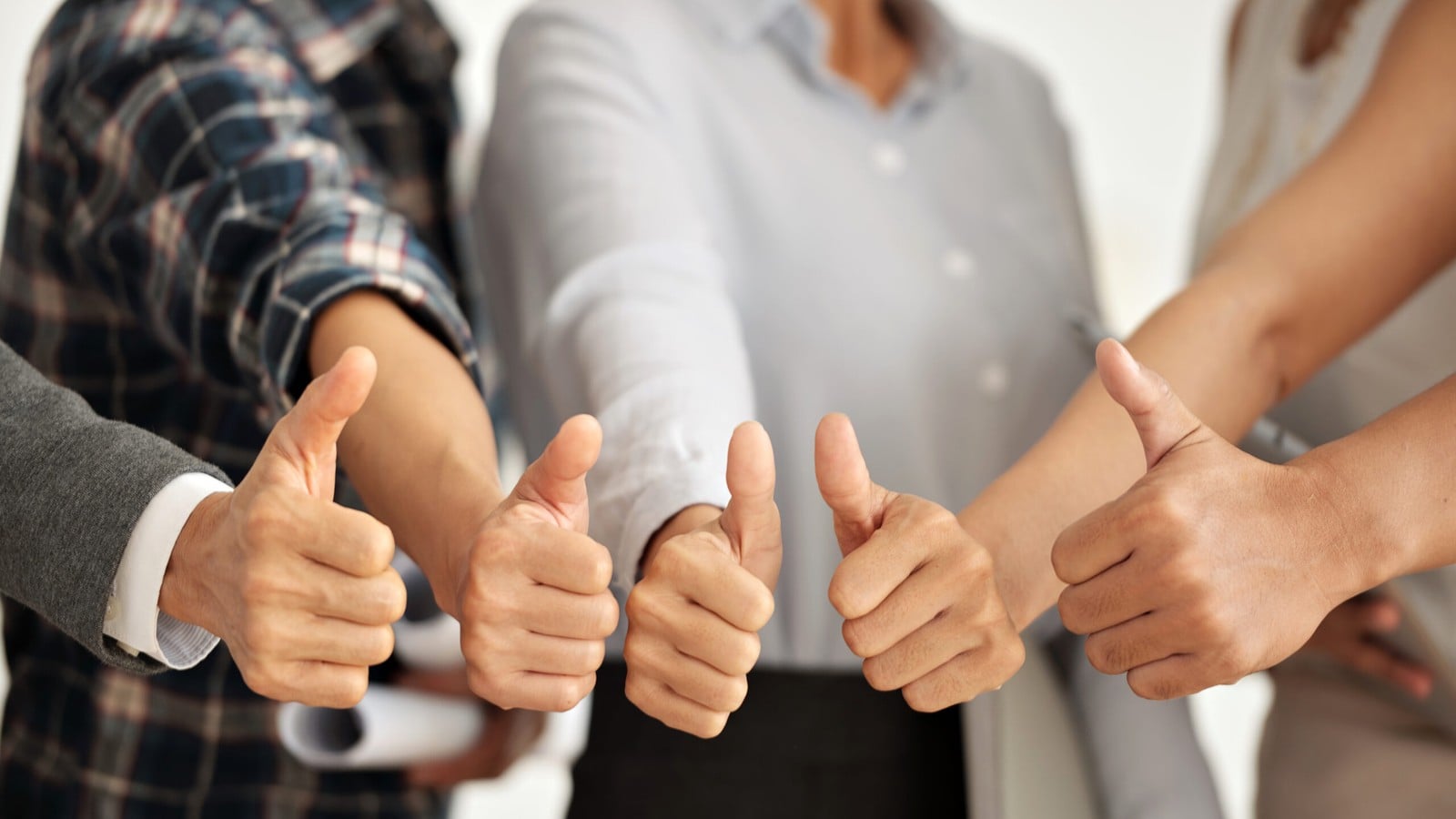 Colleagues giving four thumbs up